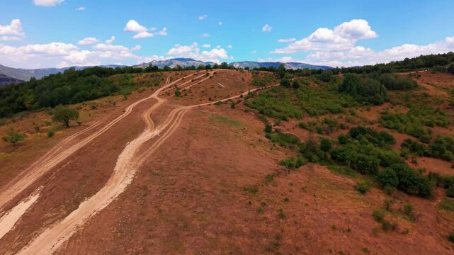 Aerial Flyover Over Zuc Hill Top Revealing Dirt Trails and Vogosca Valley Horizon Bosnia