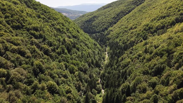 Aerial View of Road Passing Through Dense Forest Between Massive Hills in Radica Potok Near Vogosca Bosnia