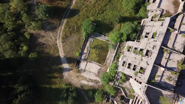 Aerial Top Down View of Abandoned Swimming Pool Beside Ruined Igman Hotel in Bosnia