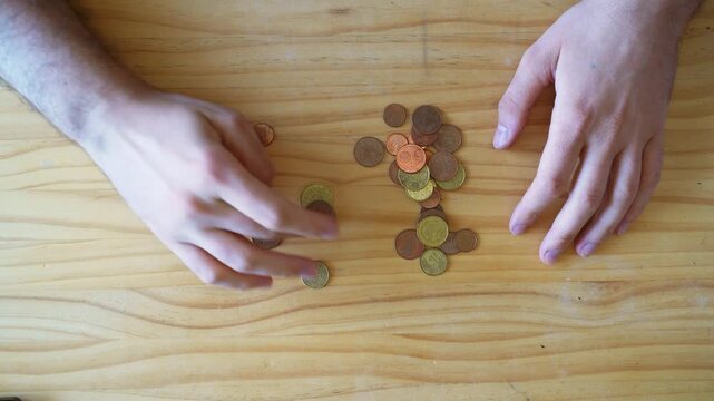 Cash and physical money concept. Savings. Hand couinting Coins onver wooden table