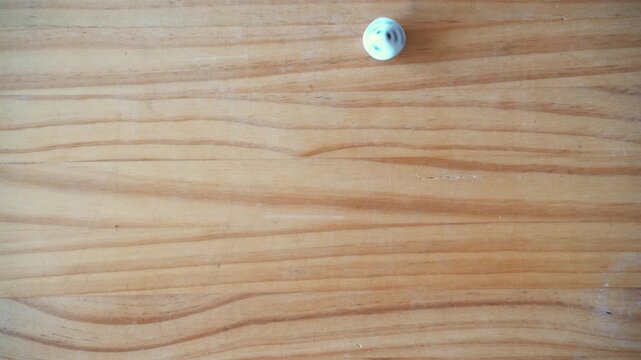 uncertainty concept. Gamble. Bet. Options. Top view of hands makind dice spin over wooden table