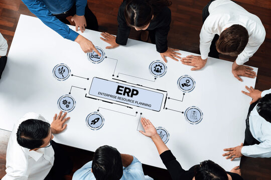 A diverse team of professionals engaged in an ERP implementation discussion, utilizing charts and diagrams to map out strategies for business success. Trope