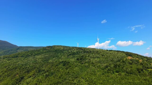 Aerial View of Wind Turbines on Forested Mountain Ridge Near Ivan Sedlo Pass Bosnia
