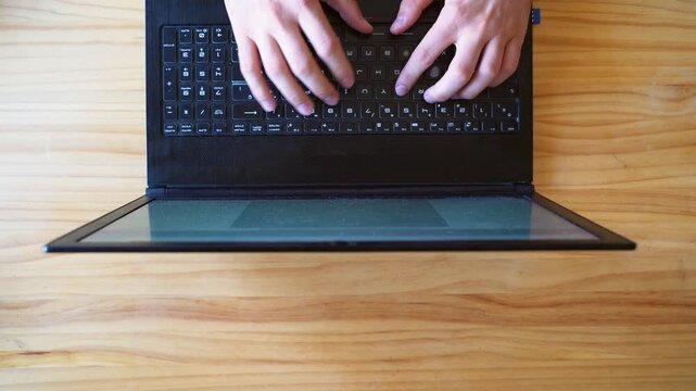 Top view shot of hands using laptop