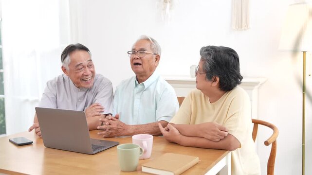 A group of three elderly people&mdash;two men and one woman&mdash;are using laptops to consult a doctor remotely via video call about taking pain medication for their illnesses together in a nursing home.