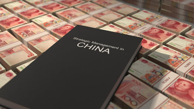 Strategic management in China book on top of Chinese yuan bill bundles