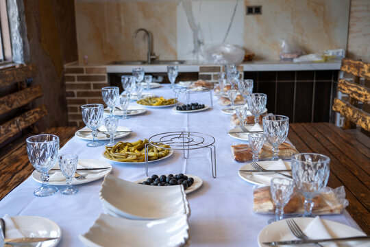Elegant Dining Table Set with Traditional Appetizers and Olives in Restaurant.