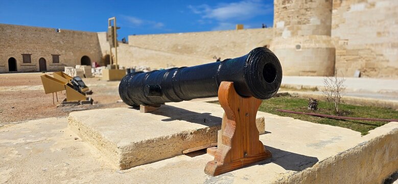 Old historic cannon in the inner courtyard of the Citadel of Qaitbay, a 15th-century defensive fortress located on the Mediterranean sea coast, on Pharos Island in Alexandria, Egypt. 