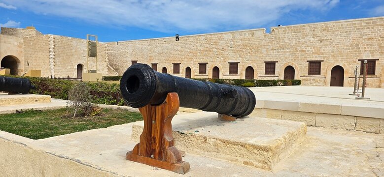 Old historic cannon in the inner courtyard of the Citadel of Qaitbay, a 15th-century defensive fortress located on the Mediterranean sea coast, on Pharos Island in Alexandria, Egypt. 