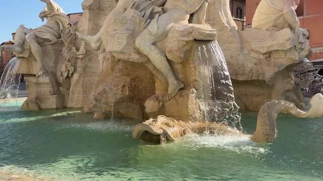 Slow motion tilt up shot of Four Rivers Fountain in Piazza Navona Rome