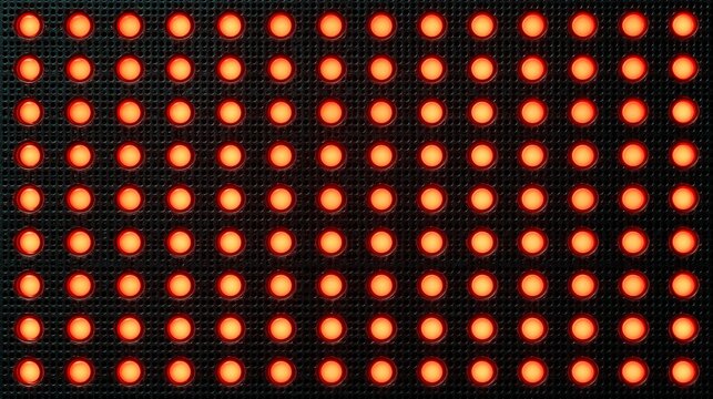 Glowing orange LED lights on black perforated grid panel