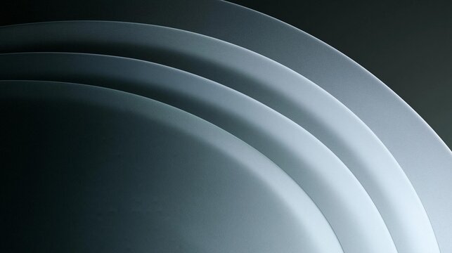 Close-up of a curved surface with a dark background. the surface appears to be made up of multiple layers of different shades of grey, creating a gradient effect.