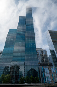 Jeanne Gang's St. Regis Chicago rises into the clouds, an example of skyscraper glass engineered to prevent deadly bird strikes, Chicago, Illinois, July 2026.