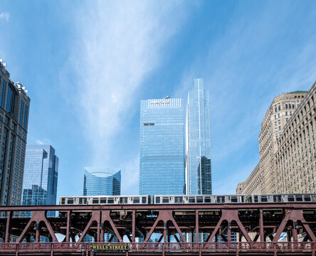 A CTA train crosses the Chicago River, after state funding averted a feared transit 'doomsday' of major service cuts in 2026, Chicago, Illinois, July 2026.