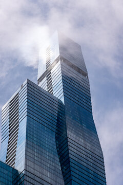 Jeanne Gang's St. Regis Chicago rises into the clouds, an example of skyscraper glass engineered to prevent deadly bird strikes, Chicago, Illinois, July 2026.