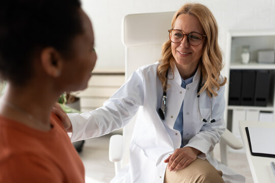 Doctor showing empathy and human connection while supporting an emotional patient during an important medical consultation