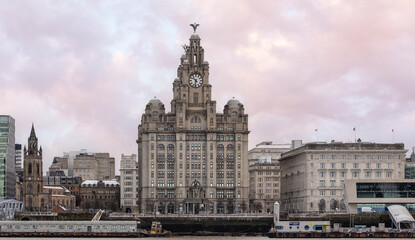 Obraz premium Liverpool, united kingdom January, 16, 2024 Royal Liver Building And Liverpool Waterfront Landmark With Clock Tower At Sunset Sky