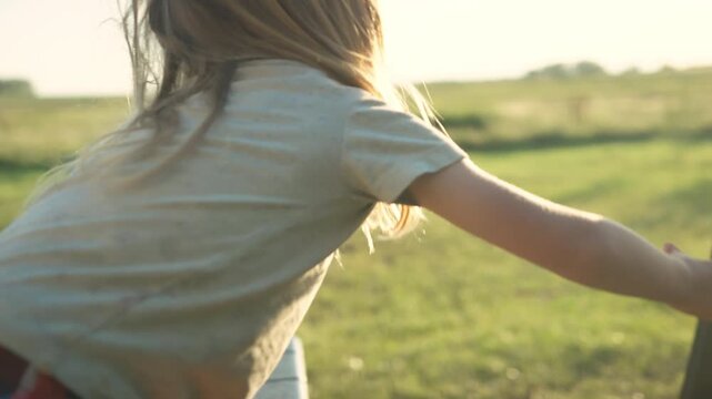 Boy with blonde hair smiling in close-up at golden hour in rural green field