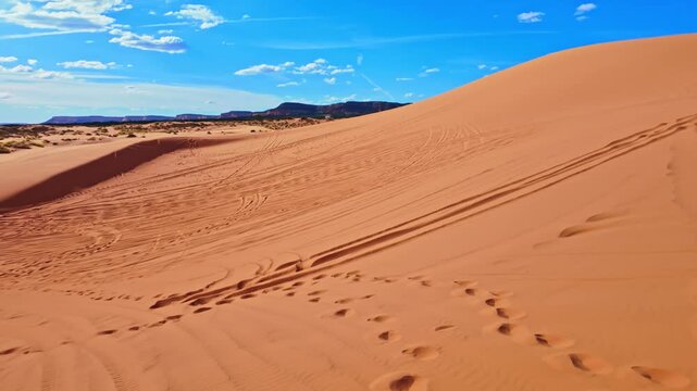 Golden sunset light glows across the panoramic landscape of Coral Pink Sand Dunes State Park in Utah