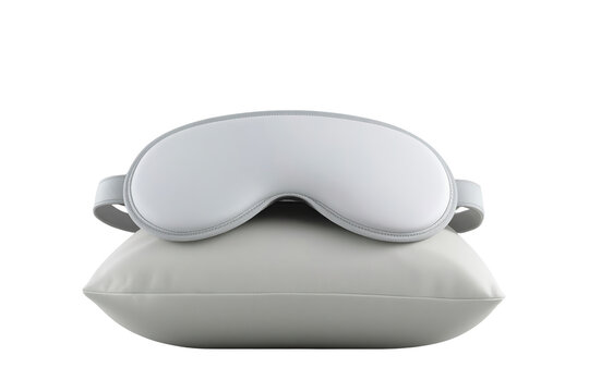 White padded sleep mask resting on soft gray pillow