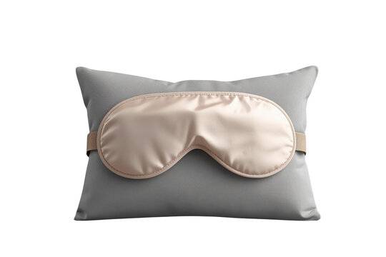 Champagne satin sleep mask displayed on gray pillow