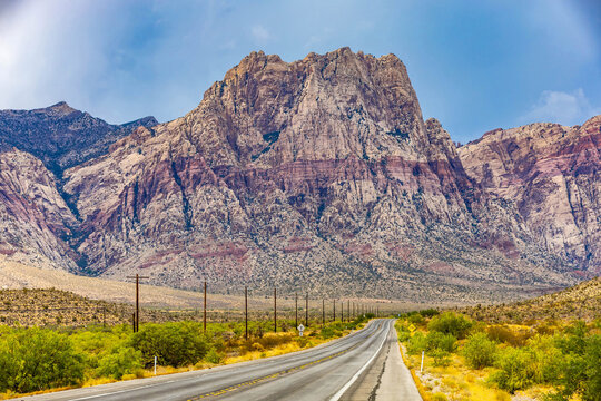 Scenic highway curving through red rock canyon panoramic view