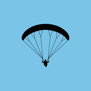Silhouette Of Paraglider Ascending Into Bright Blue Sky