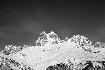 Black and white snowy mountains at sunny winter day © BSANI