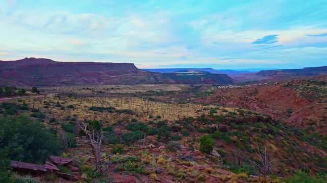 Golden sunrise light glows across the panoramic aerial view of Zion mesa valley in Utah