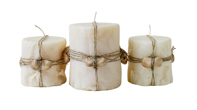 Isolated three natural handmade candles wrapped with rustic twine and decorative wooden beads