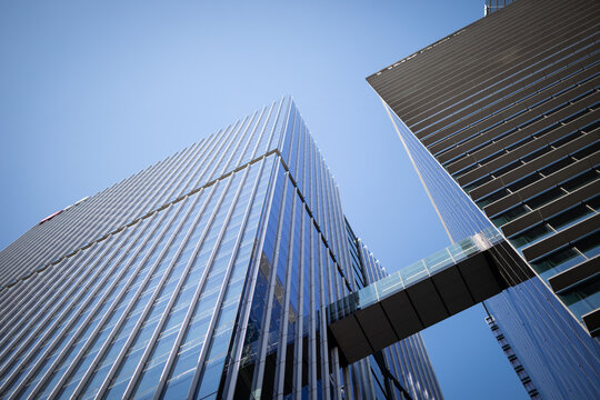 Modern skyscrapers connected glass bridge under sky