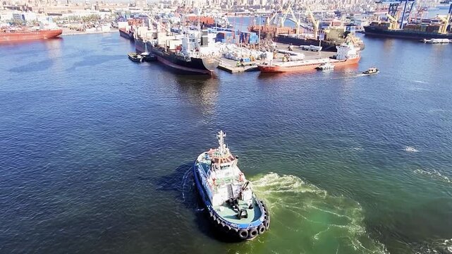 Marine traffic with tugboat escorting passenger cruise ship from Alexandria Port, Egypt. Handheld