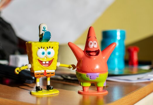Athens,Greece-December 8,2018.Old and used SpongeBob SquarePants and Patrick toys on a wooden surface. 