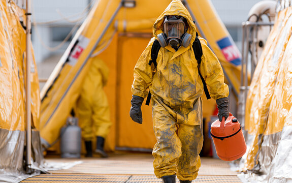 Man in chemical protection suit, carrying out the decontamination area