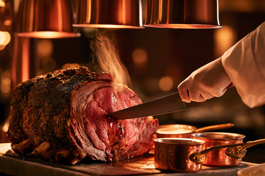 chef slicing juicy prime rib at a hotel carving station