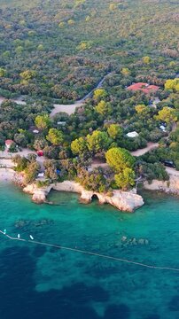 FKK Naturist Baldarin Campsite In Punta Kriza On Cres Island, Croatia, Filmed By Drone During A Beautiful Summer Evening. Aerial Views Show Campervans, Motorhomes, Coastal Nature at Sunset