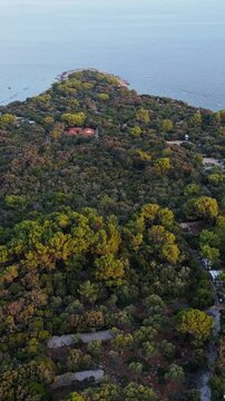 FKK Naturist Baldarin Campsite In Punta Kriza On Cres Island, Croatia, Filmed By Drone During A Beautiful Summer Evening. Aerial Views Show Campervans, Motorhomes, Coastal Nature at Sunset