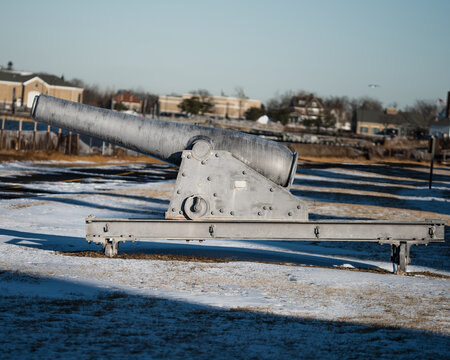 Historic Old Rodman Smoothbore Cannon in Coastal Fortress Overlooking Scenic Sky and Water, Preserving Military Heritage and Defense History in a Peaceful Landscape