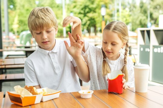 Older Brother and Younger Sister Arguing Over Fast Food