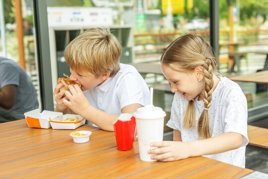 Happy Children Enjoying Fast Food Together