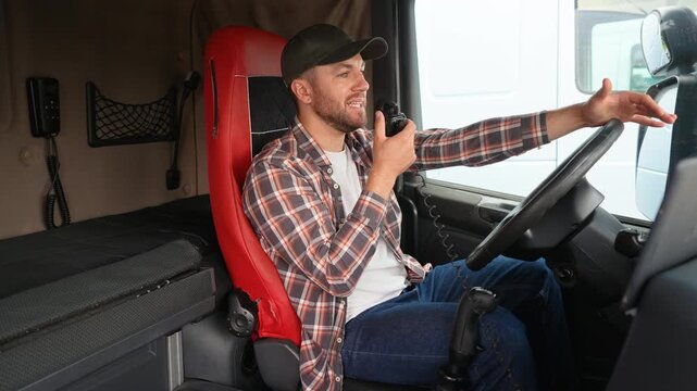 Professional truck driver talking on cb radio inside cabin