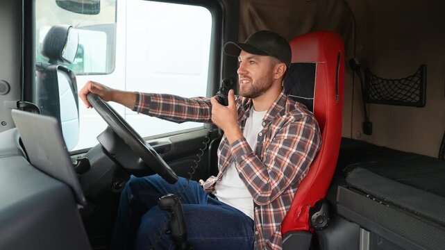 Professional truck driver speaking on cb radio in right hand drive car
