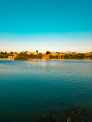 Naklejka premium River, houses and blue sky 