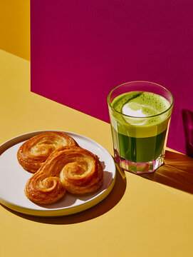 The Palmier pastry sits next to the matcha espresso latte