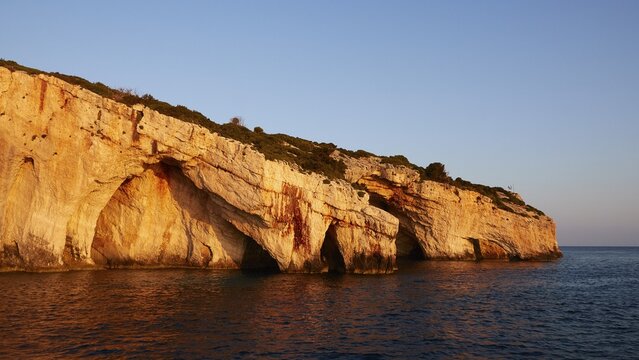 Blue Caves, morning light, rocky coast, blue cloudless sky, northeast coast, Zakynthos Island, Ionian Islands, Greece