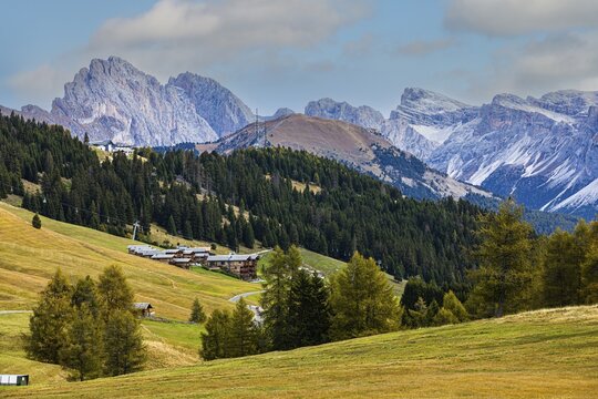 Wellness Resort Adler Mountain Lodge on the Alpe di Siusi, behind the snow-capped peaks of the Geisler and Puez groups, Val Gardena, Dolomites, South Tyrol, Italy