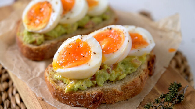 Avocado Toast Topped with Jammy Soft Boiled Eggs on Sourdough Bread