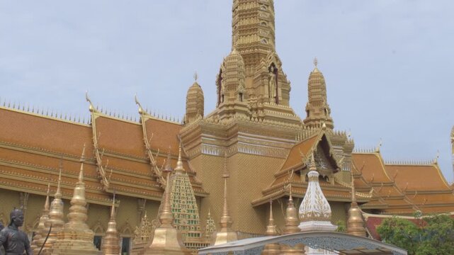 ornate golden stupas tiered rooflines and towering central prang at the great hall of vajradhamma in ancient city, thailand 