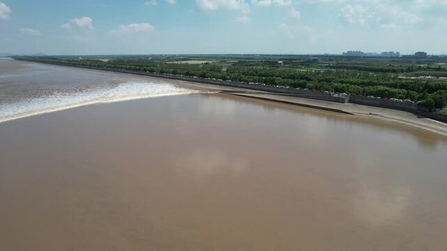 Wide tidal bore crossing the Qiantang River estuary in China