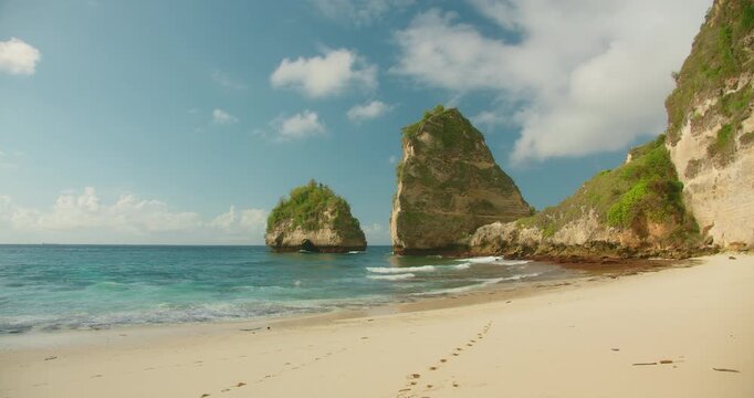 Footprints lead across the pristine white sand of Diamond Beach in Nusa Penida Indonesia